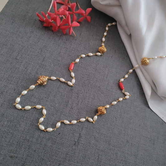 Long pearl string with coral and golden beads