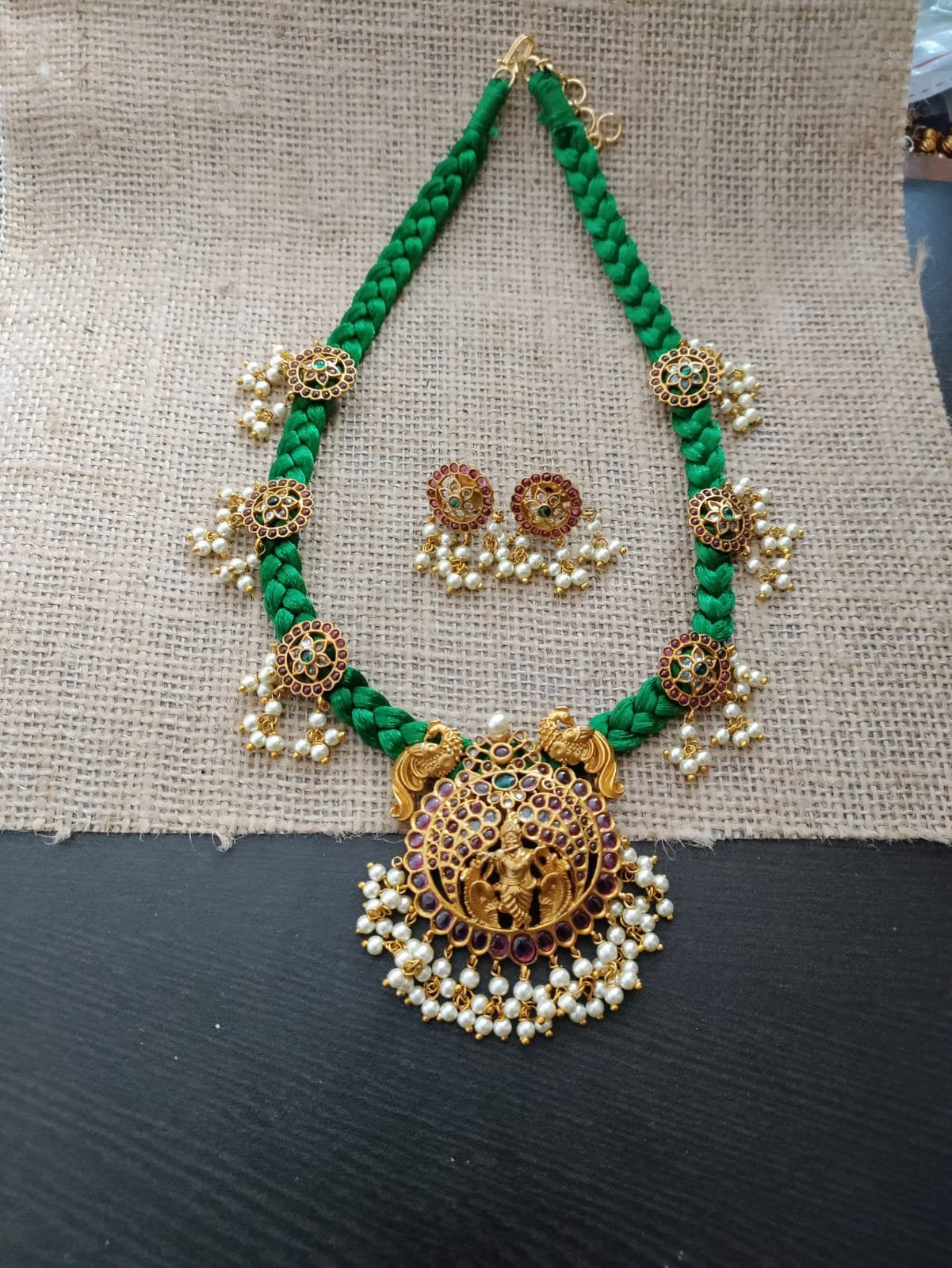 Green threaded necklace set with kemp krishna pendant